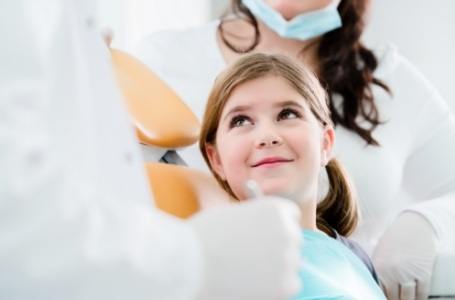 Pediatric dentist talking to patient about radiation free tooth decay detection tools
