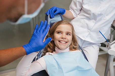 a child giving a high-five to their dentist