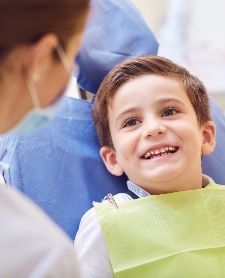 Child smiling during tooth extraction visit
