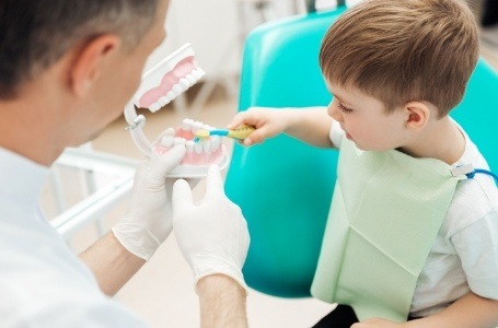 Dentist giving child aftercare tips following tooth extractions