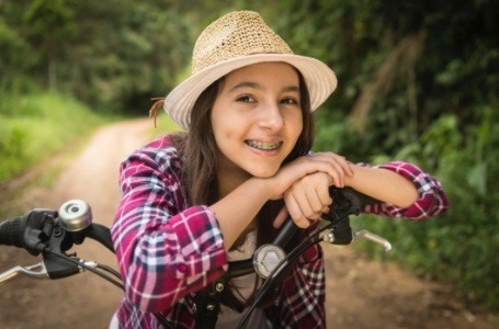 Young woman smiling after dentistry for teens