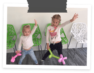 Two kids dancing in Allen dental office waiting room