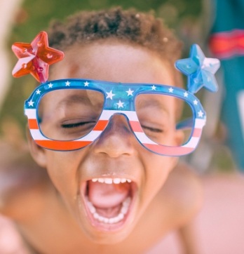 Child with red white and blue glasses