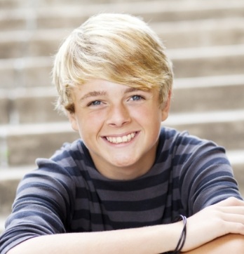 Teen boy in striped shirt smiling
