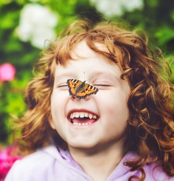 Little girl with butterfly on her nose