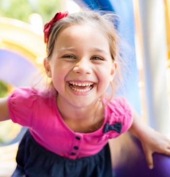 Young girl smiling on a playground