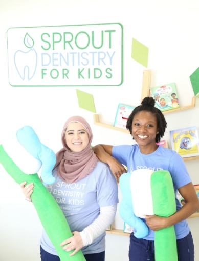 Allen dental team members with oversized toothbrushes