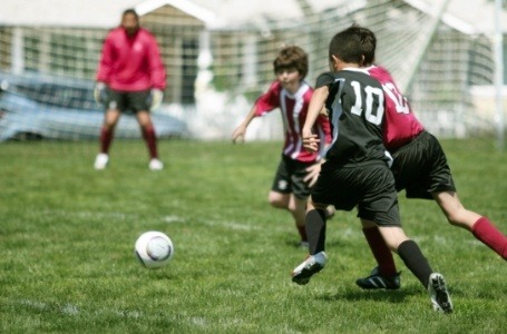 Kids playing soccer with sportsguards