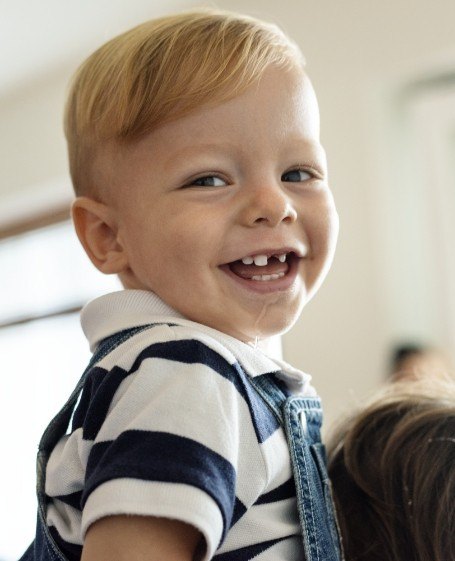 Child with healthy smile after restorative dentistry