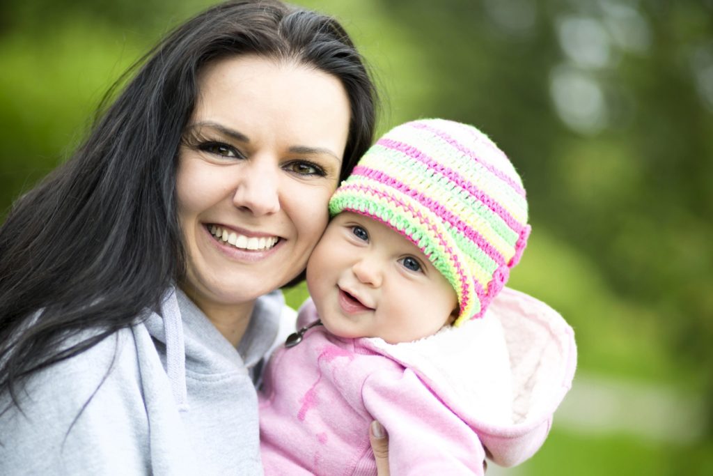 parent and baby smiling 